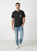Man wearing a black t-shirt with a pocket design and light blue jeans on a white background