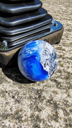 Side view of The Bad Coupe Resin Shifter Ball showing the swirled blue and white marbled resin finish and the gloss clear dome over the artwork