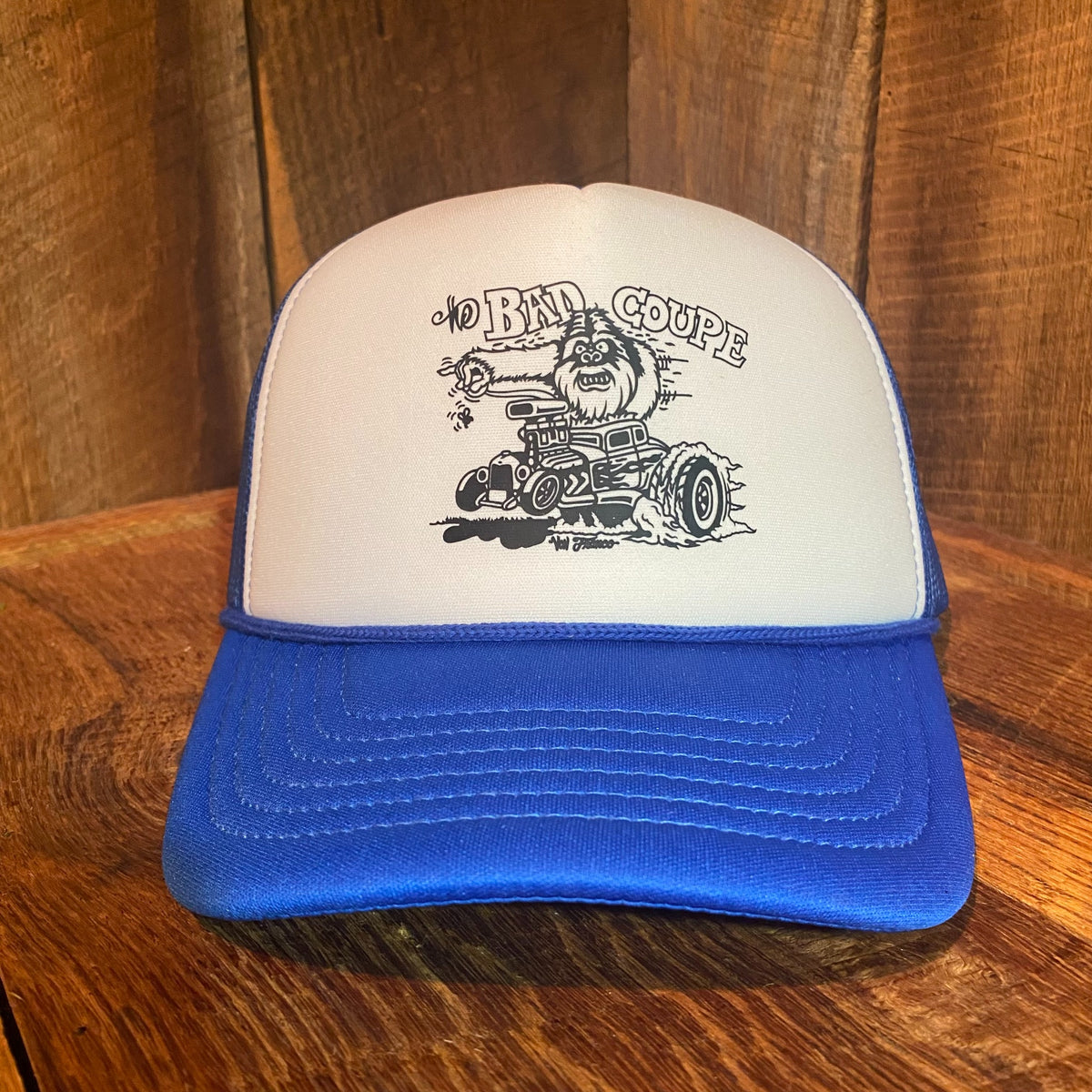 Front view of The Bad Coupe Yeti Foam Trucker Hat in blue and white, featuring Von Franco's original hand-drawn Kustom Kulture Yeti hot rod graphic on the foam front panel