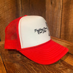 Left side view of The Lady Luck Foam Trucker Hat in red and white, showing the foam front profile and breathable mesh back