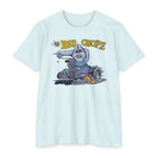 The Bad Coupe Yeti T-Shirt in Ice Blue laid flat, showing Von Franco's full-color artwork of a white Yeti driving a flame-throwing chopped hot rod coupe beneath yellow The Bad Coupe lettering