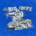 Blue t-shirt with a graphic of a yeti driving a hot rod and 'The Bad Coupe' text.